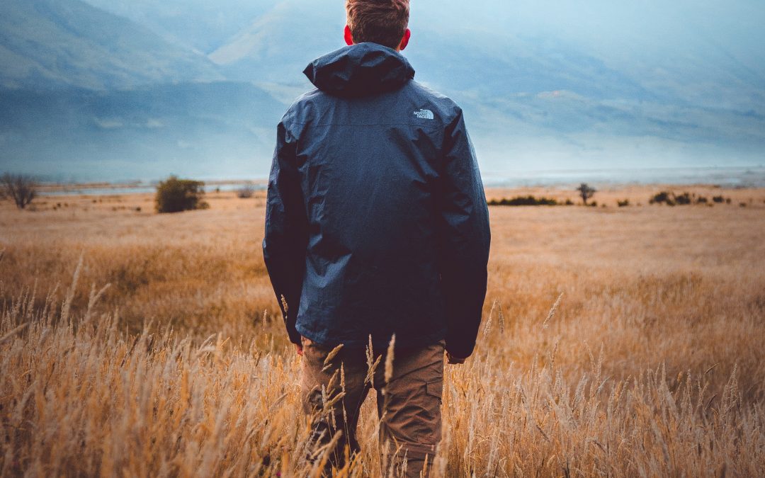 man standing in the fields looking away