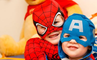 toddlers in super hero costumes in school event