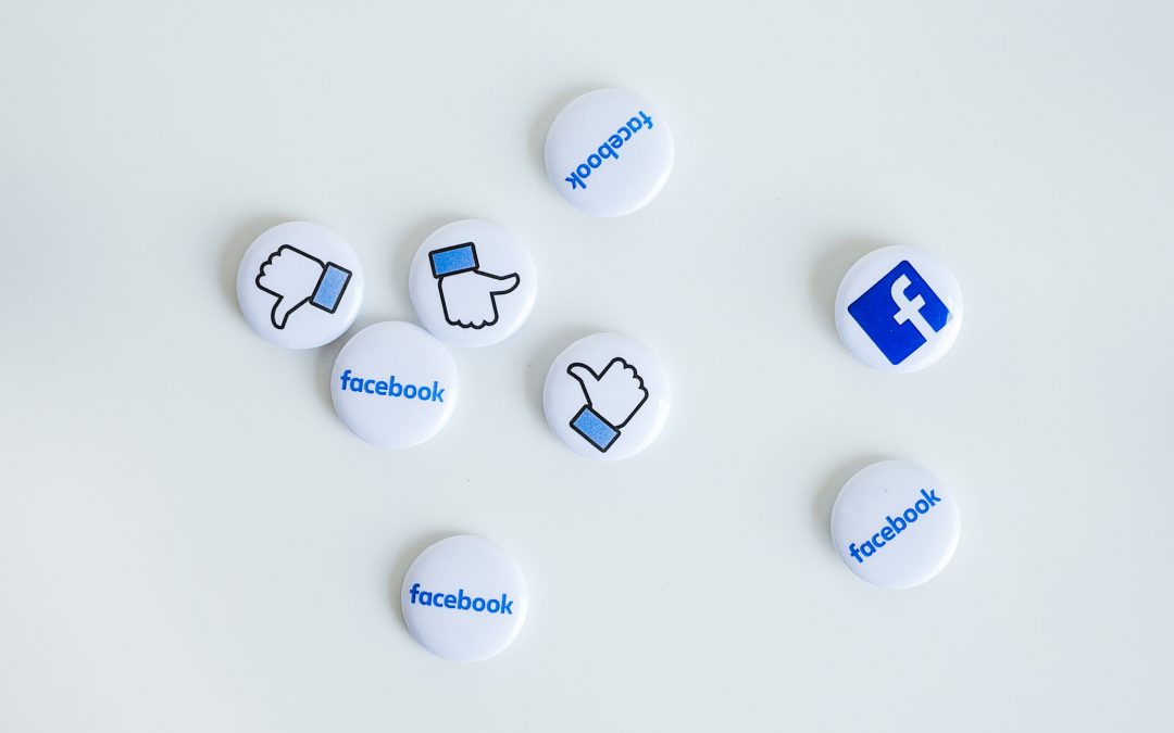 small buttons scattered on a white background with Facebook icons