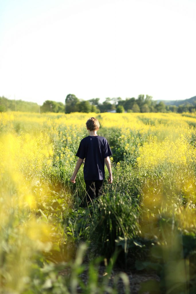 teen walking alone in a field
