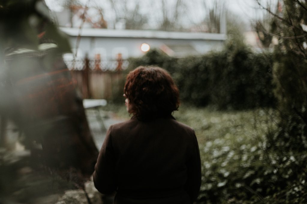 woman standing alone in a yard