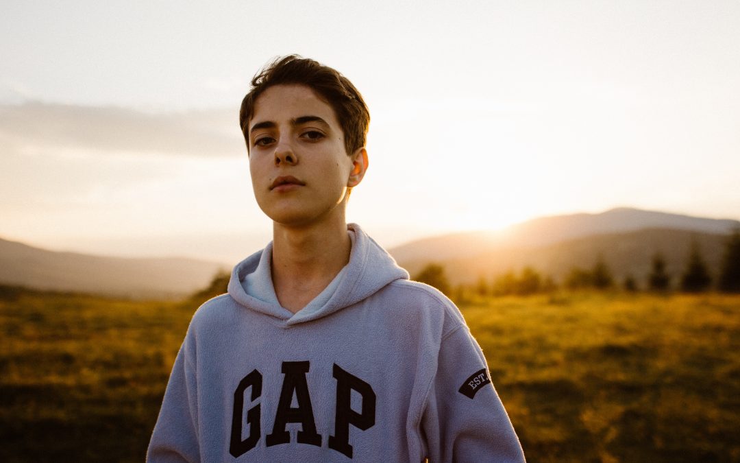 Teen boy spending time outside during the coronavirus quarantine struggling with missing friends in need of online therapy Los Angeles and teen therapy in Simi Valley, Ca