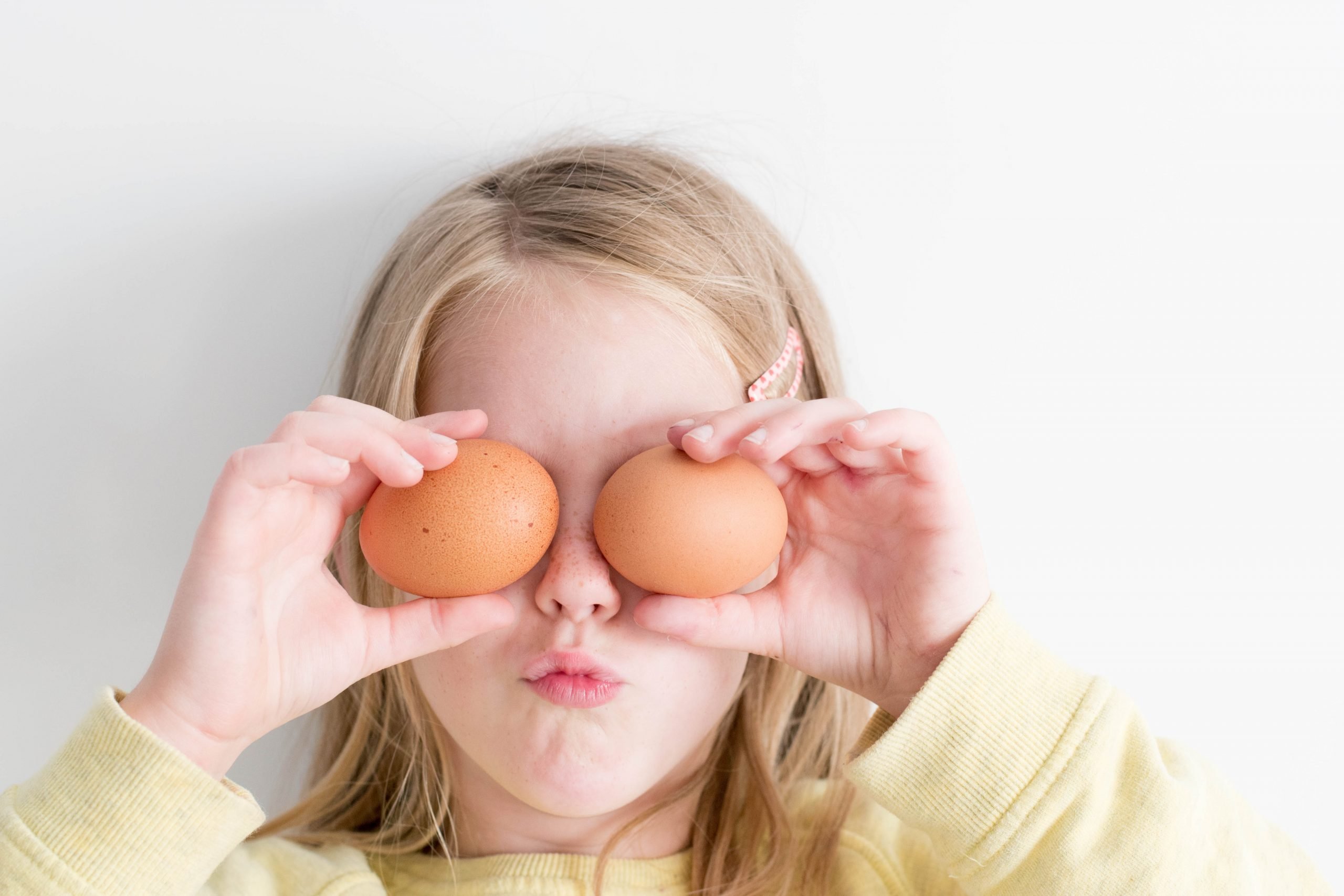 Girl having fun with eggs after getting help for social concerns with autism testing in Simi Valley, Ca
