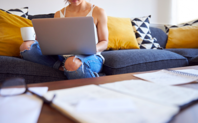 woman in jeans working on a laptop