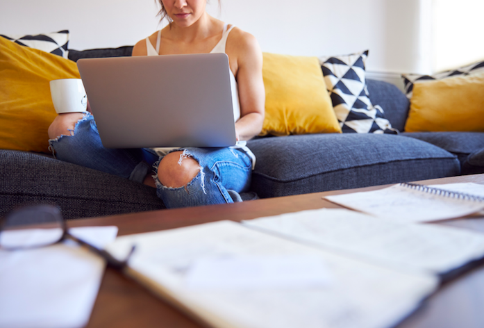 woman in jeans working on a laptop