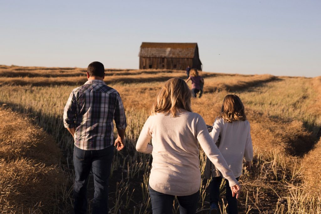 family walking towards a barn