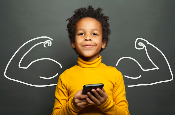 boy holding a cell phone in front of a wall with the drawing on muscular arms