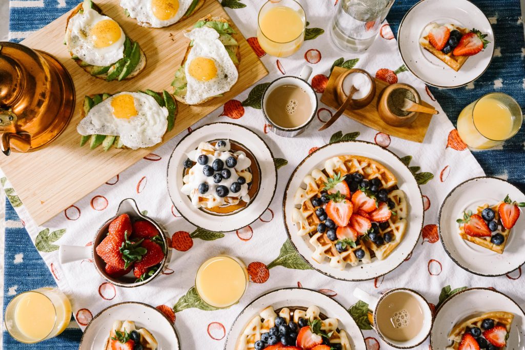 a table filled with plates of breakfast items