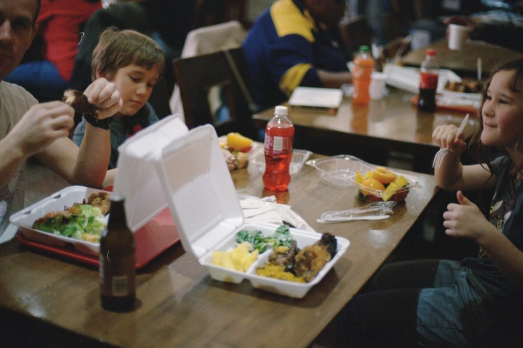kids eating in a long dinning hall 
