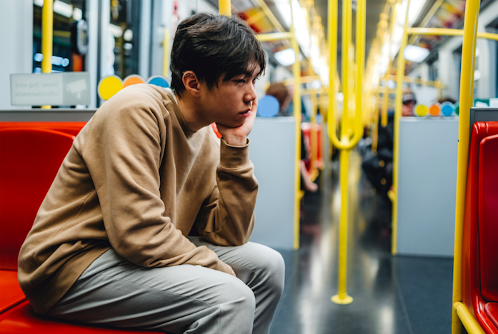 sad man sitting alone in bus