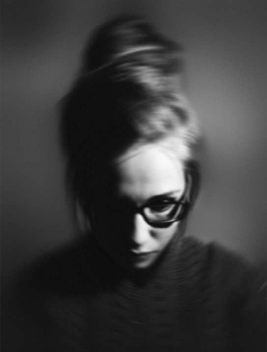 woman with bun and wearing glasses, 