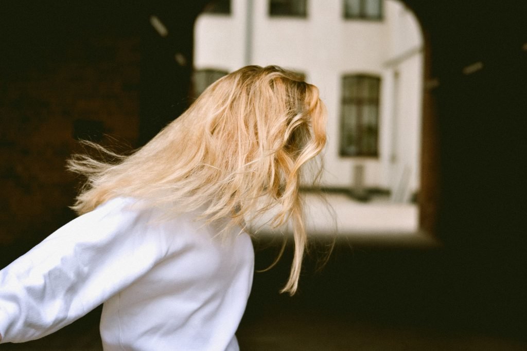 woman in white tshirt and hair flowing in hair