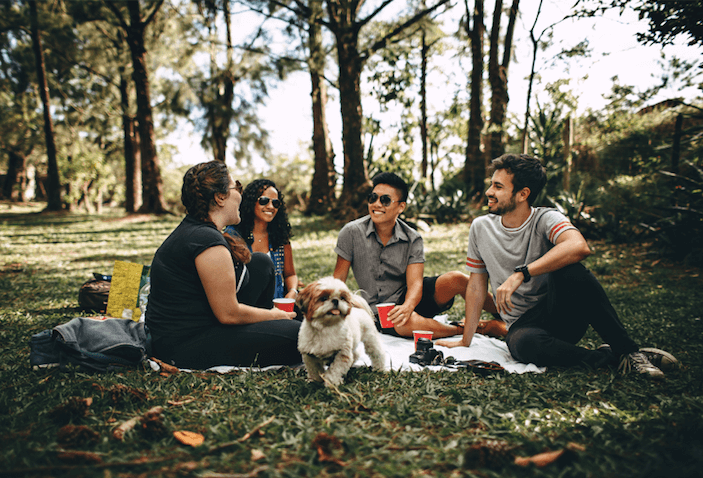 group of friends and dog hanging in a park having a picnic after they had anxiety therapy in Simi Valley, ca
