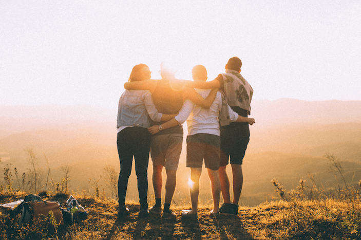group of friends hiking together and spending time with one struggling with social anxiety