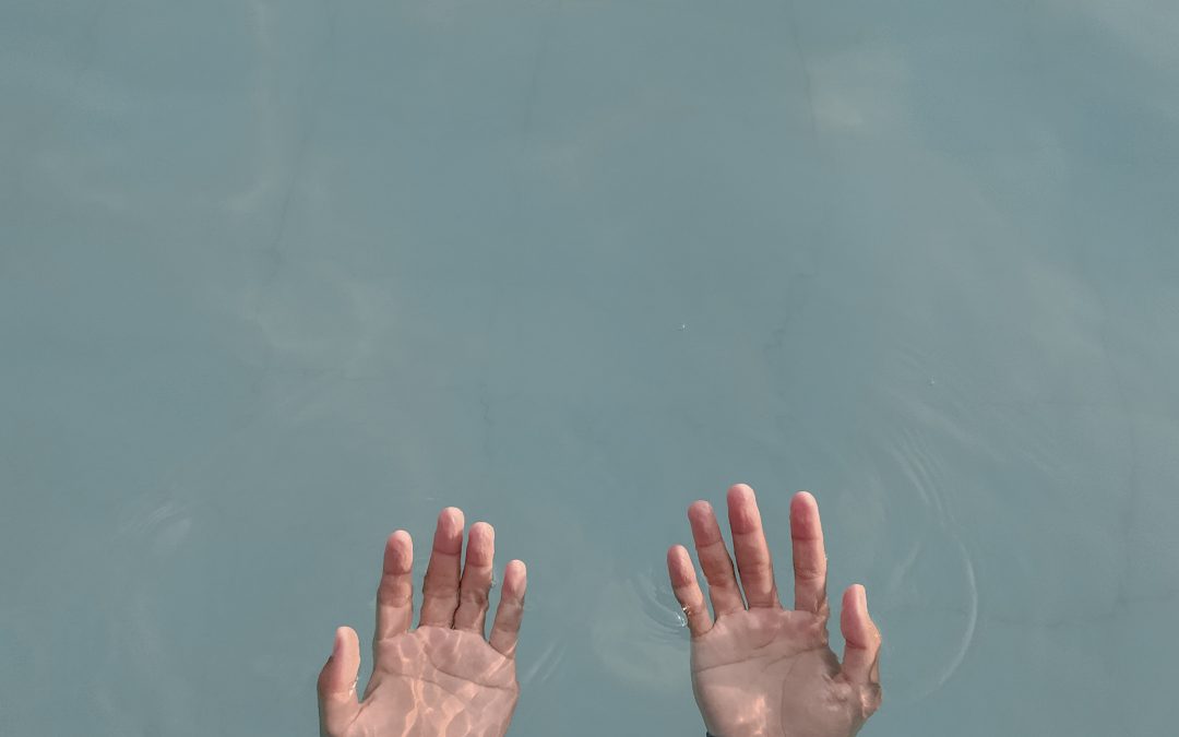 hands emerging from water palms up