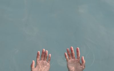 hands emerging from water palms up