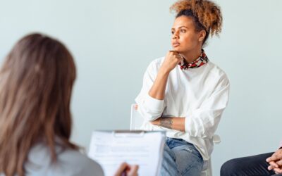 woman sitting in a group in front of a therapist