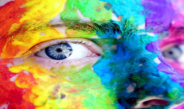 close up face with rainbow paint