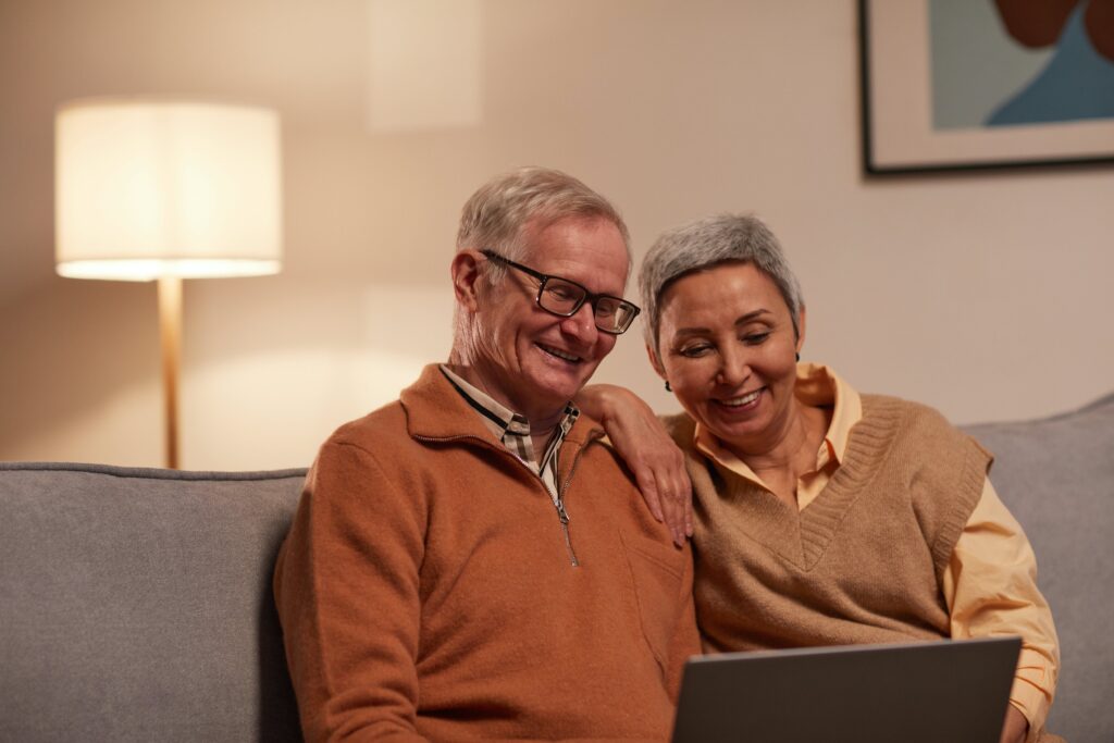 Couple looking at computer smiling