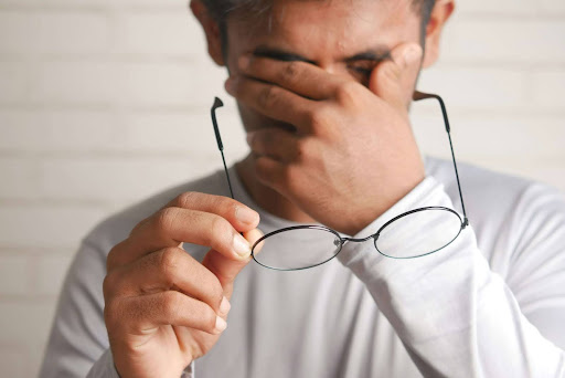a person holding glasses to his face
