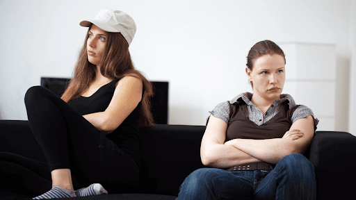 a couple of women sitting on a couch