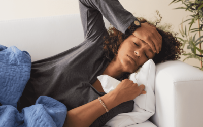 A woman lies asleep on a couch, her head supported by a pillow, creating a scene of calm and restful slumber.